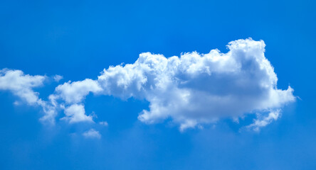 Cotton ball A lonely cloud moves freely across the blue sky. The gentle movement of an atmospheric front. A majestic swirling spectacle.