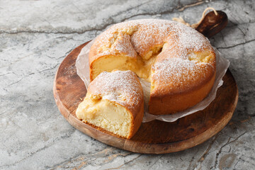Italian Custard Cake or Torta Nua is a quintessentially dessert known for its minimalistic appearance and decadent flavor closeup on the wooden board on the table. Horizontal