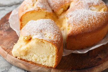 Torta Nua Italian Cake with Crema pasticcera closeup on the wooden board on the table. Horizontal
