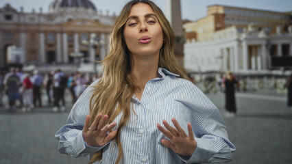 Woman in striped shirt spreads bare hands in vatican square with crowd behind; serenity calm travel...