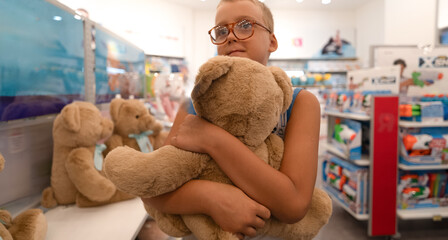 teddy bear in kids hand in shopping mall