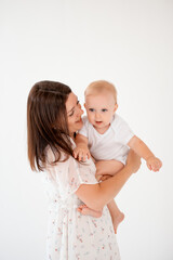 baby with mother, place and space for text, mother holding baby in her arms on a white isolated background, maternal love and care, portrait of mother and baby