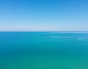 Vast expanse of turquoise sea meeting a clear blue sky