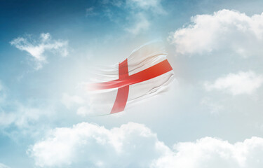 England flag waving light background hidden in the sky.