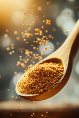 Wooden spoon with golden granules falling in sunlight, symbolizing eco wellness, superfood, and holistic natural nutrition. Perfect for organic lifestyle and health visuals