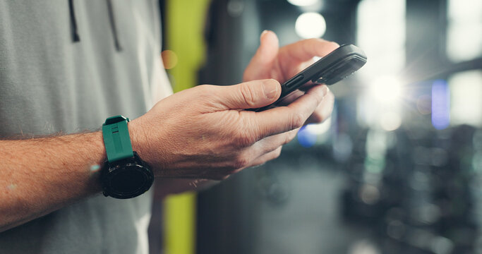 Fitness, gym and hands of man with phone on mobile app for health, wellness and track workout. Sports center, typing and person on smartphone for internet, exercise website and training progress