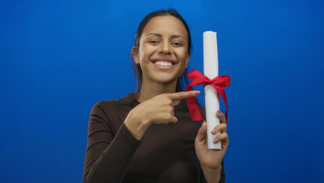 Woman holding diploma against blue background with red ribbon symbolizing graduation success and education achievement.