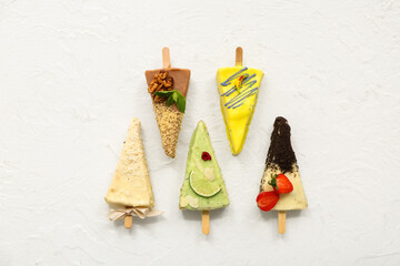 Tasty cheesecake pops on white background