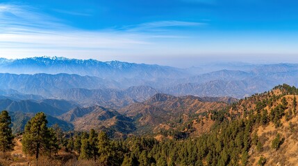 Fototapeta premium A panoramic view of distant mountains under a clear blue sky showcases natural beauty and serenity, Perfect for travel blogs, nature documentaries, or environmental campaigns,