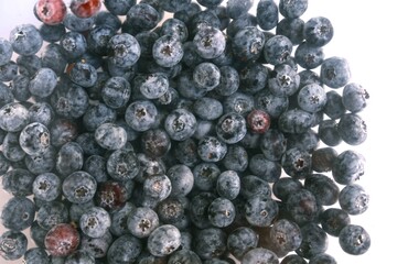Close-up of fresh blueberries with natural texture, perfect for culinary magazines, food blogs, and healthy recipe backgrounds.