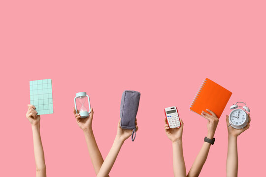 Many hands with notebooks, calculator and alarm clock on pink background - Powered by Adobe