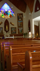Pews inside a serene church featuring stunning stained glass windows and elegant wooden decor creating a peaceful indoor atmosphere perfect for worship and reflection.
