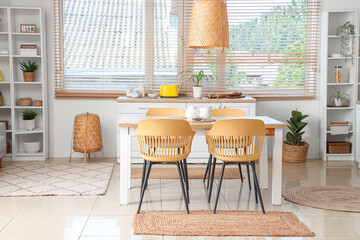 Dining table and chairs near large window in kitchen