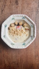 a plate of mashed potato with sautéed mushroom and eggs