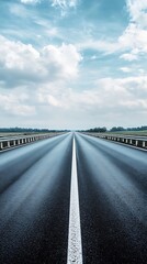 Fototapeta premium Endless highway under a cloudy sky with central white line and side rails