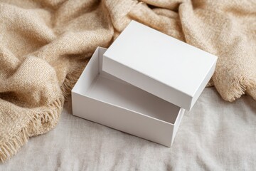 Mockup for design of empty gift boxes on a cozy fabric background. Box with lid
