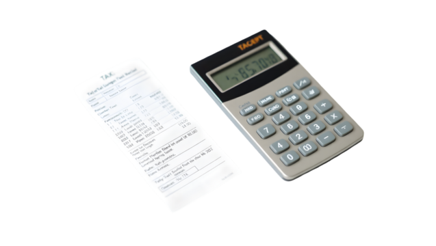 Calculator and tax document showing financial calculations on a dark background surface