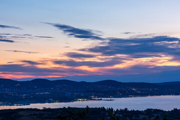 Sunrise colors breaking through clouds at Lake Balaton