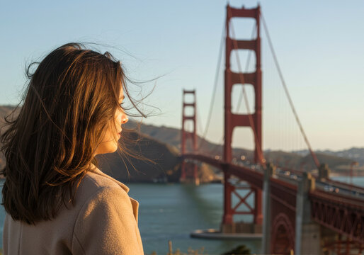 Woman Admiring Golden Gate Bridge and San Francisco Bay Scenery at Sunset - Powered by Adobe