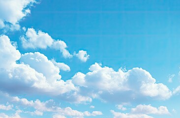 Fluffy white clouds against a vibrant blue sky