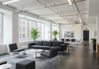 Fototapeta premium Modern Office Lounge and Meeting Area With Large Windows and Plants
