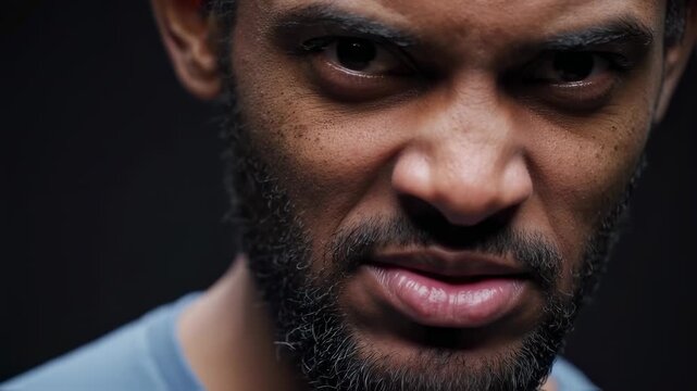 Dramatic Extreme Close-Up of a Bearded Man with an Intense, Piercing Gaze into the Camera