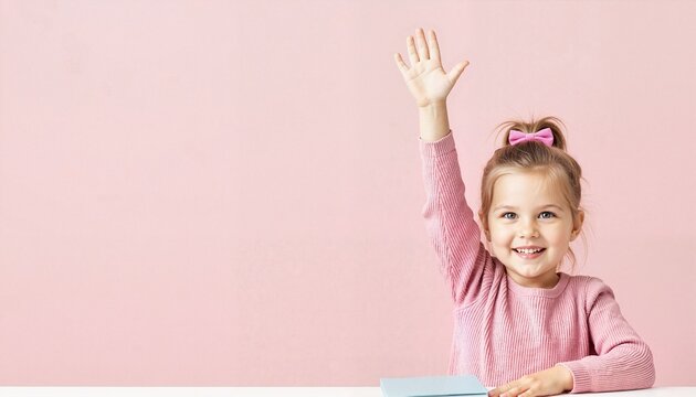 Young girl raising hand and smiling on flat pink background  