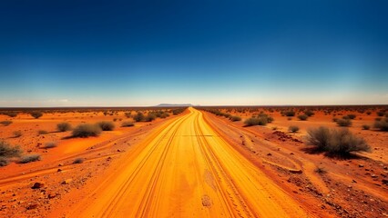 Endless outback trail on dusty road toward distant horizon