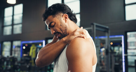 Shoulder pain, exercise and man in gym, joint injury and inflammation with muscle tension. Massage,...
