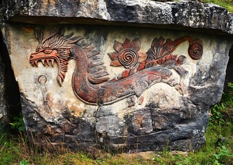 10. Ancient mural with mythological creatures on stone