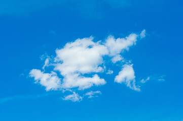 Blue sky background with white clouds. White fluffy clouds on the sky. White clouds on a beautiful blue sky