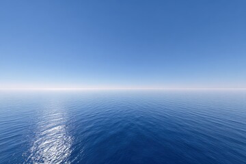 Fototapeta premium Wide expanse of still blue ocean meeting a clear blue sky