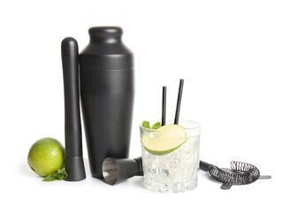 Shaker, muddler, measure cup, lime, strainer and glass with cocktail isolated on white background