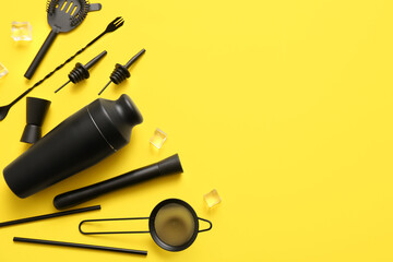 Composition with bartender kit and ice cubes on yellow background, closeup