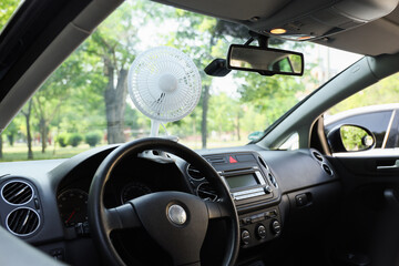 Mini electric fan on car dashboard
