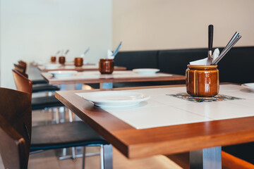 Empty wooden table and chairs in a restaurant. Selective focus.