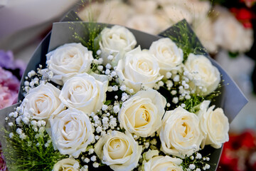 A bouquet of delicate white roses for a wedding ceremony.