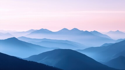 Obraz premium Serene mountain range at sunrise with misty layers