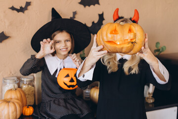 Fototapeta premium Mother and Daughter Celebrating Halloween with Carved Pumpkins
