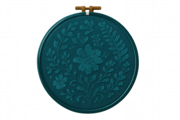 Embroidery hoop featuring delicate floral needlework on teal fabric, transparent backdrop highlighting intricate stitching details