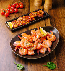 Delicious seafood platter featuring shrimp and grilled shrimp on a wooden table