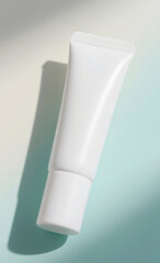 White Cosmetic Cream Tube with Soft Shadows on a Light Blue and White Background