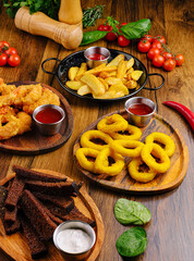 Delicious fried snacks served with dipping sauces at a rustic table