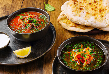Delicious bowls of soup served with warm flatbread and lemon slice