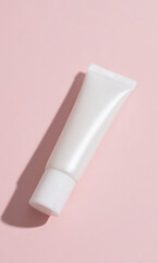 Minimalist white tube of beauty product on a soft pink background with a clean shadow, perfect for skincare, cosmetic, or personal care branding and design concepts.