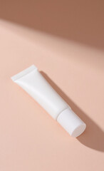 Clean white unbranded tube for skincare or beauty product presented on a minimalist pastel background with soft shadows, perfect for mockup or design.