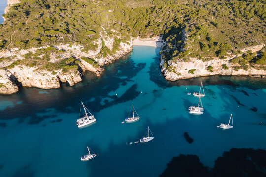 Aerial of coastline with yachts, Cala Macarella, Menorca