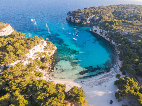 Aerial of Cala Macarella beach at sunset, Menorca