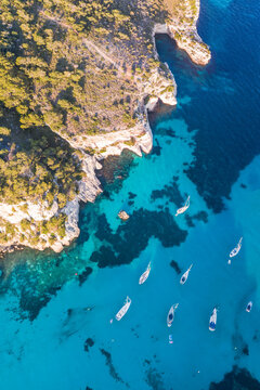 Aerial of bay and yachts, Cala Macarella, Spain