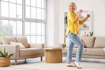 Mature woman dancing at home